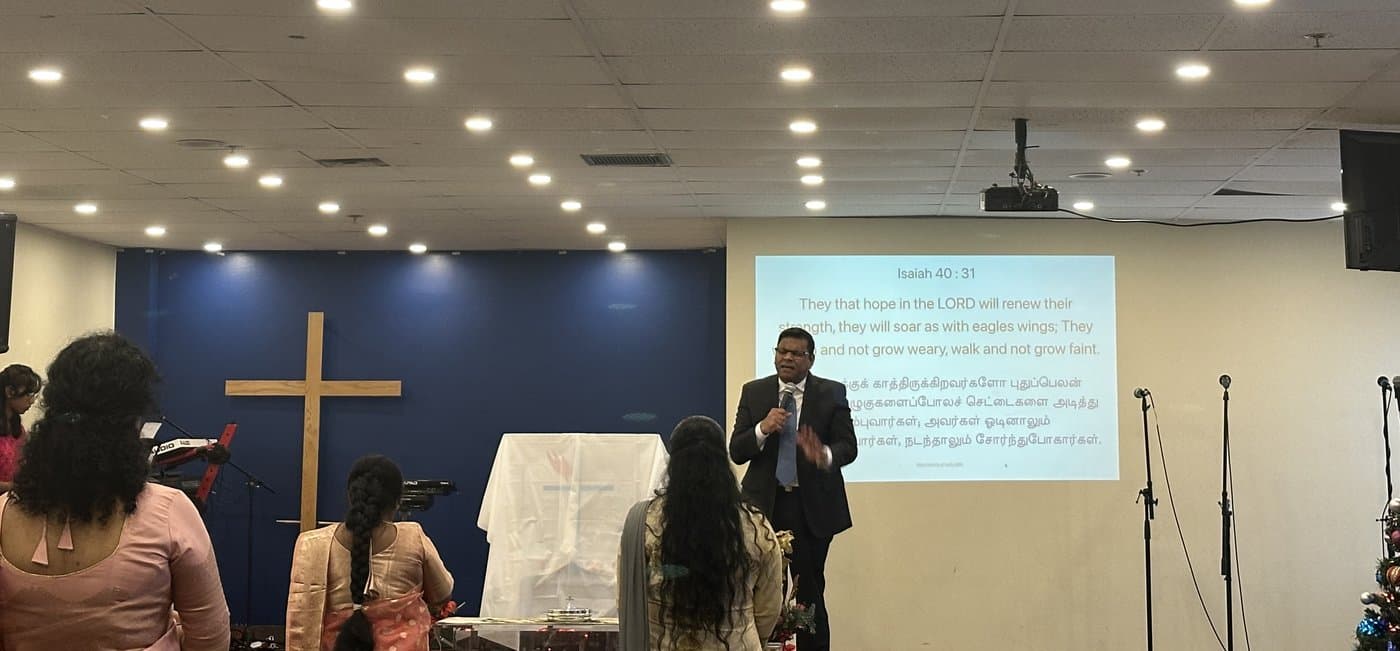 Pastor Andrew Bala preaching in the sanctuary